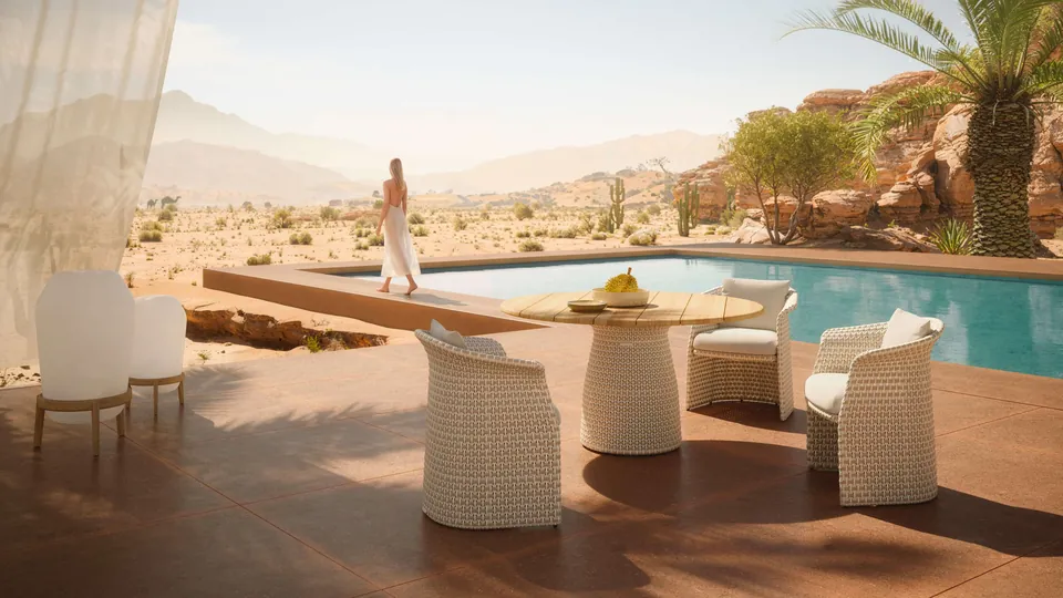 Dedon Fllair armchair and round dining table in Sahara, a patio set with a braided weave